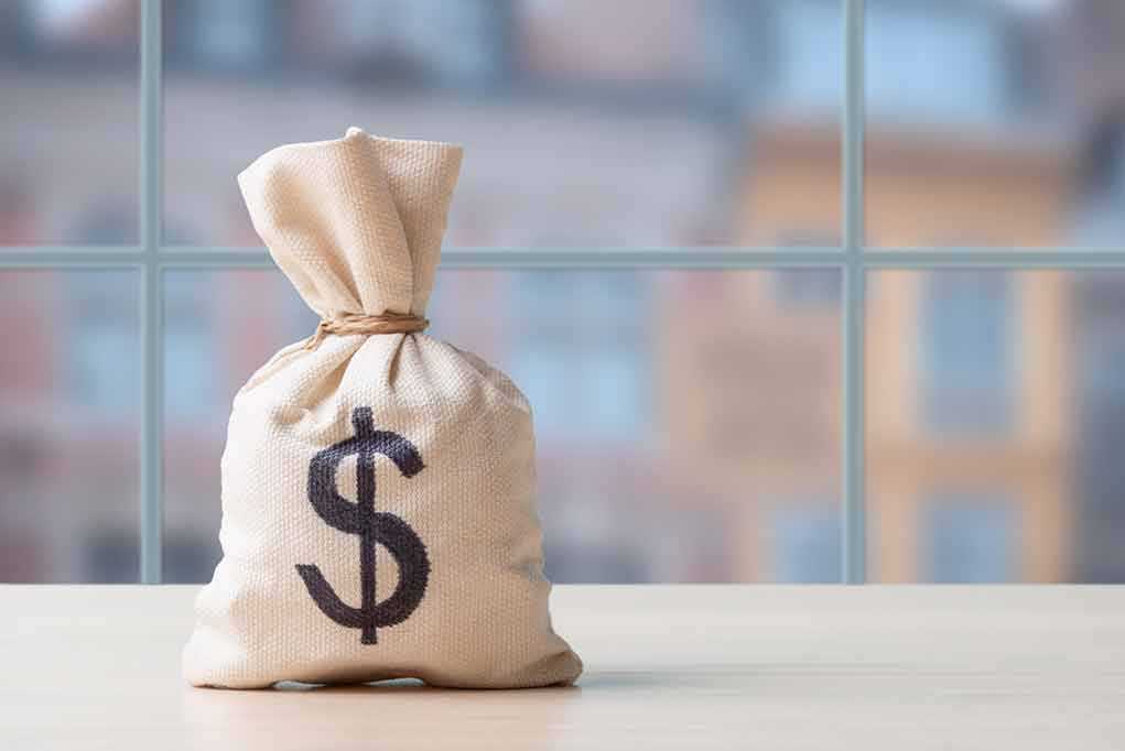 Money bag with dollar sign on table