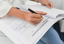 Person filling out job application form
