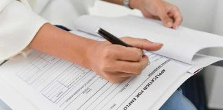 Person filling out job application form