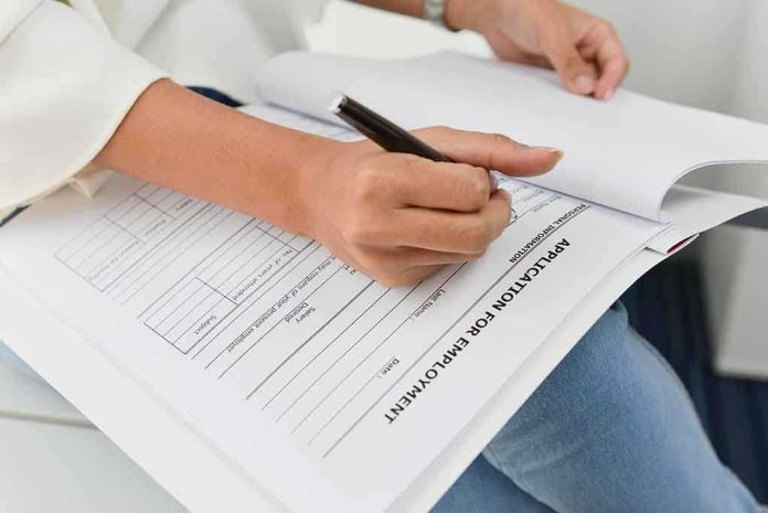420099925 featured image Person filling out job application form