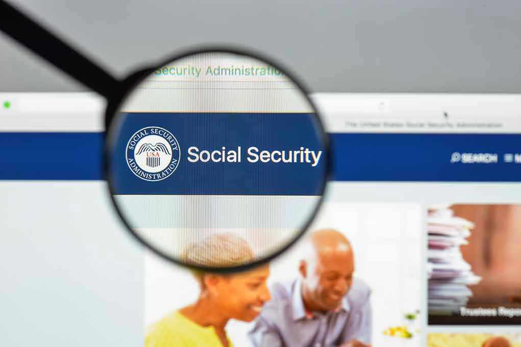 Magnifying glass focusing on Social Security Administration webpage