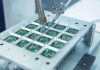 Close up of a soldering machine working on circuit boards