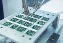Close up of a soldering machine working on circuit boards