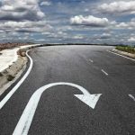 Curved road with a U-turn arrow marking.