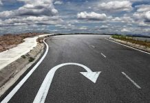 Curved road with a U-turn arrow marking.