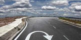 Curved road with a U-turn arrow marking.