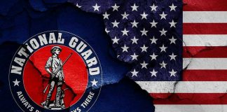 National Guard logo over a distressed American flag
