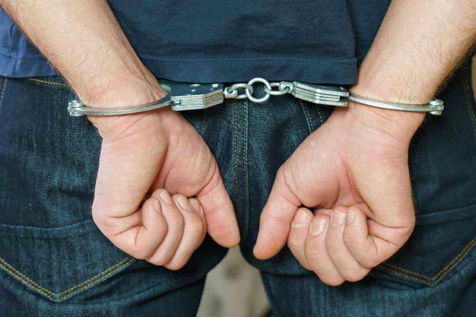 1916737259 Person in handcuffs behind their back
