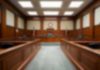 Empty courthouse courtroom with wooden benches and chairs