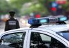 Police car and officer on a city street