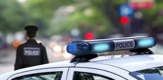 Police car and officer on a city street