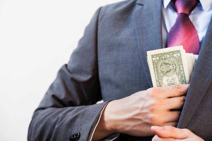 394112617 Person in suit putting money in jacket pocket.