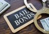 Bail bonds sign with handcuffs and stacks of cash