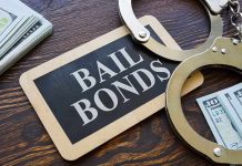 Bail bonds sign with handcuffs and stacks of cash