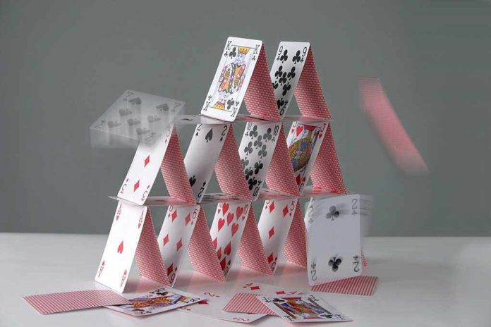 2130029 Collapsing house of cards in motion.