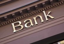 Gold bank sign on building facade