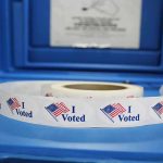 Roll of I Voted stickers on table.