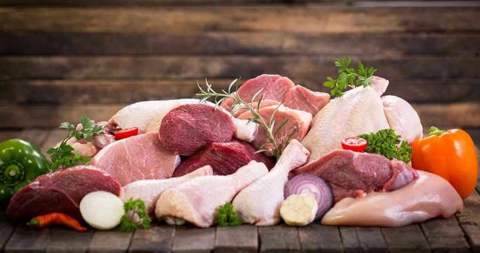 497502007 Assorted raw meat with vegetables on wooden table.